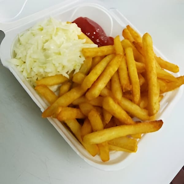 AlBasha Subs' golden french fries, coleslaw, and ketchup in a white takeout container.